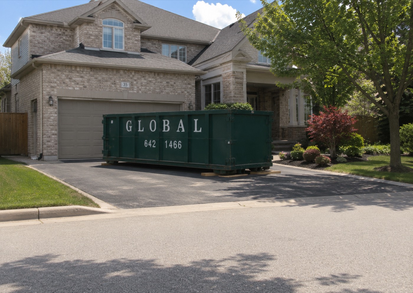 Dumpster rental delivered to a residential driveway in the GTA